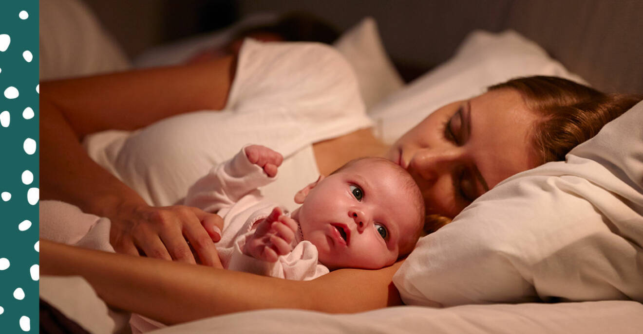 Trött mamma i sängen med sin bebis